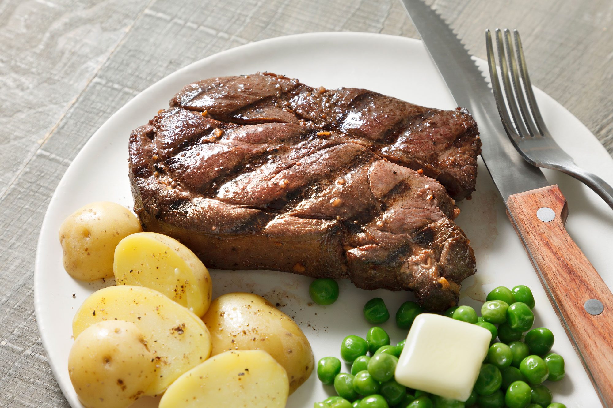 3/4th shot of Grilled Venison Steak served with veggies