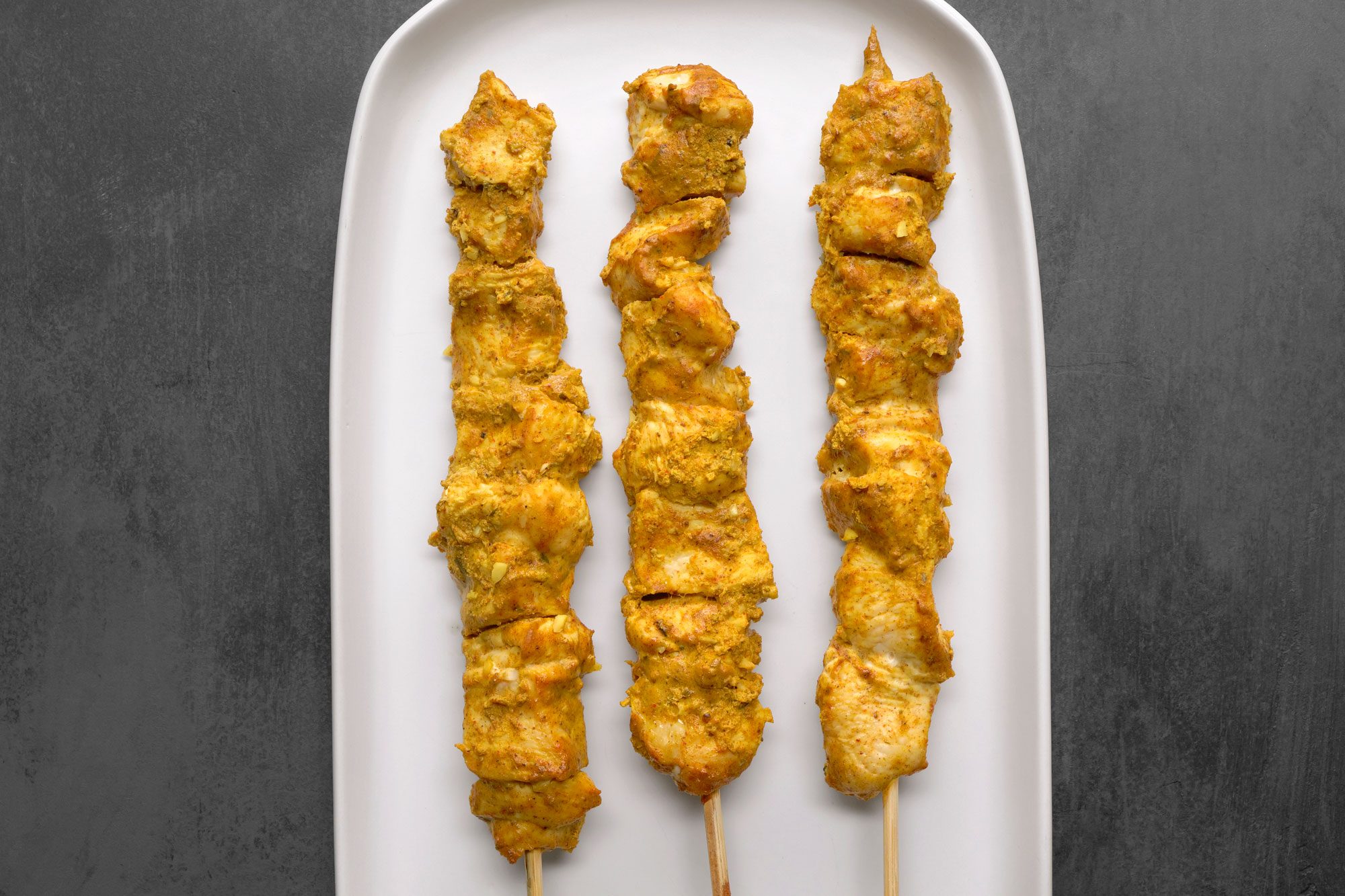 Chicken Tikka skewers served in a serving plate