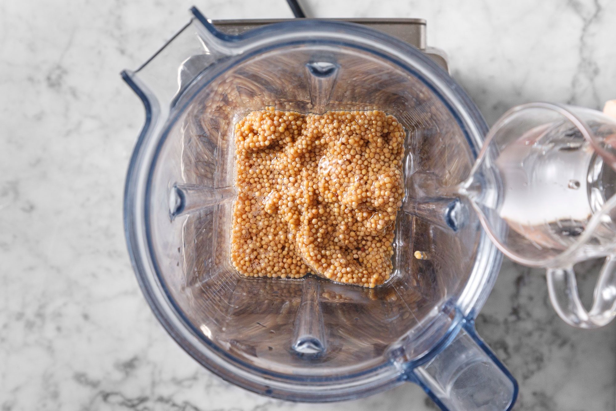 Add mustard seeds to a blender with remaining 3 tablespoons vinegar and dry white wine.