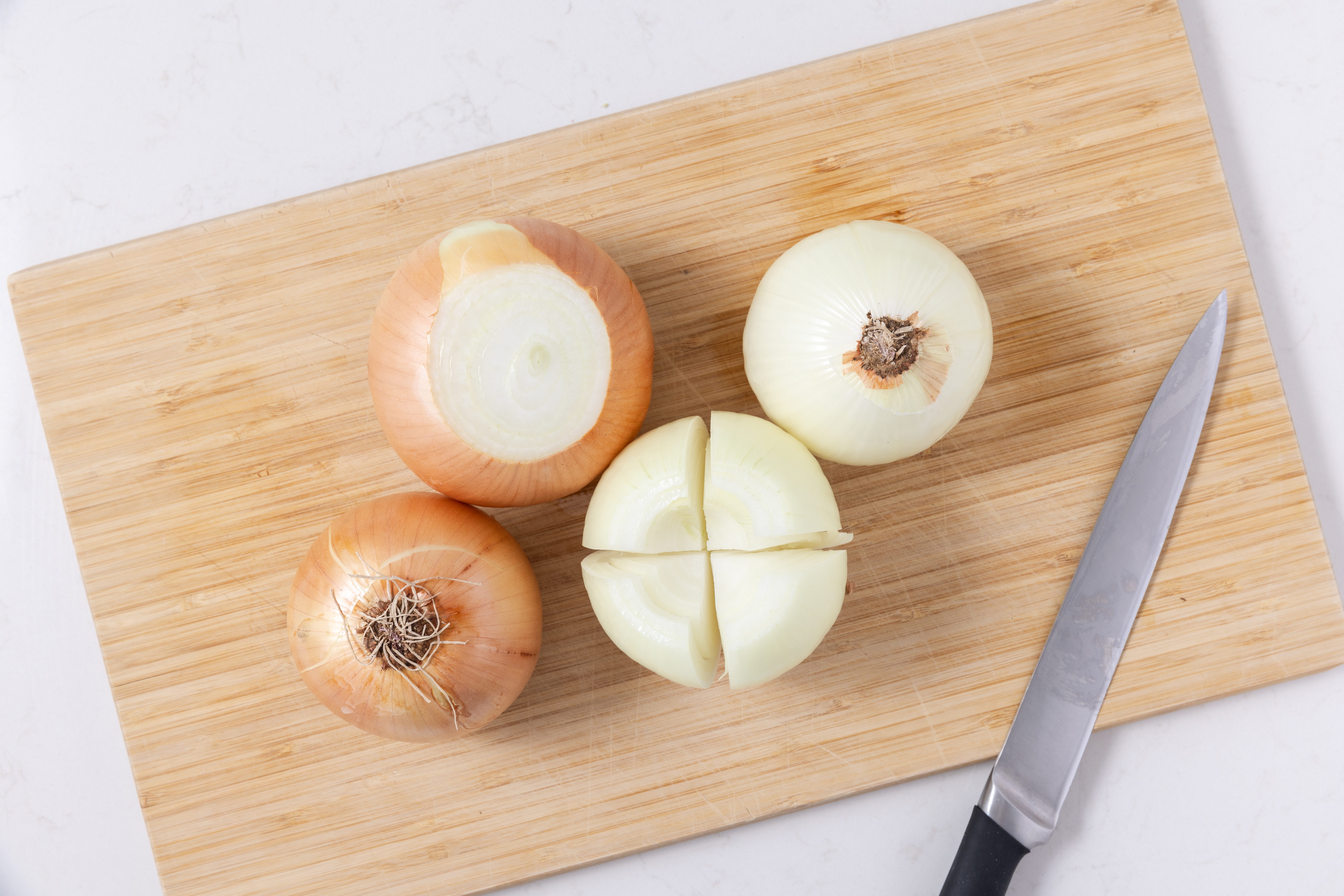 Onions being prepared cut in quarters.