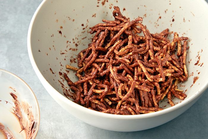 Chocolate coated noodles in a white bowl