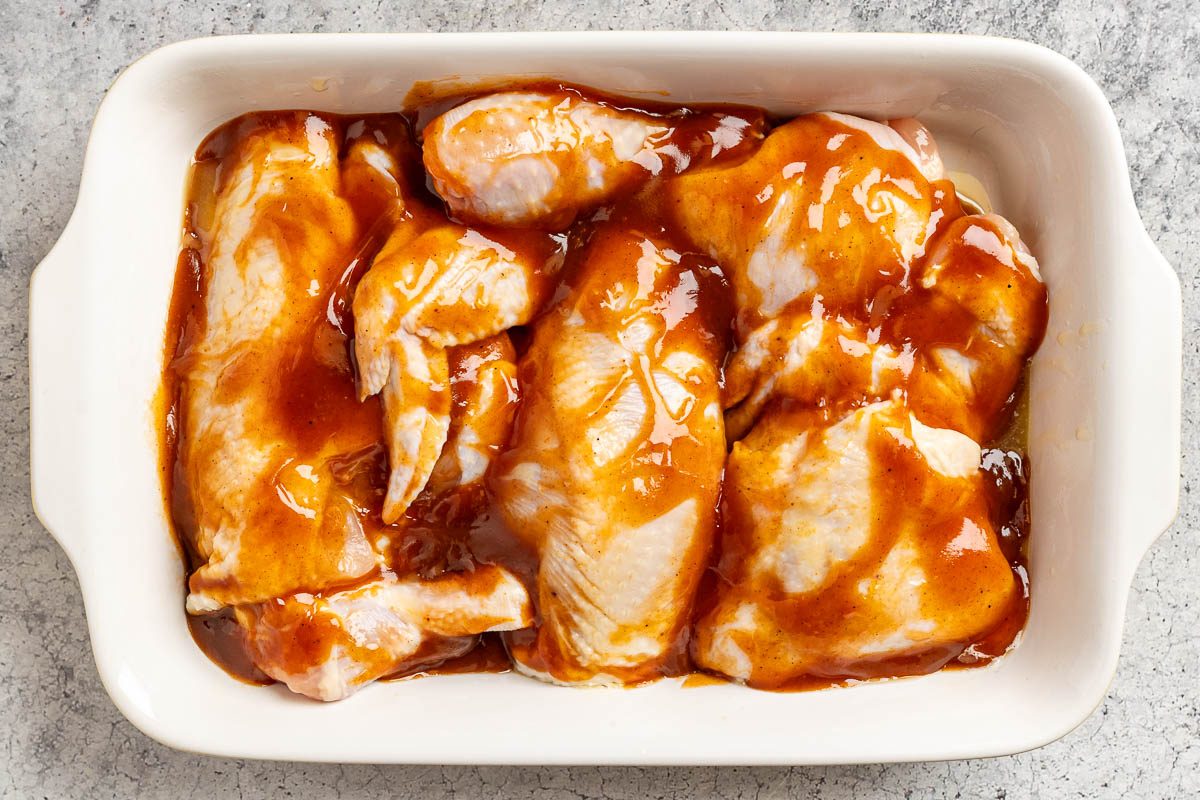 Taste of Home Hawaiian Chicken photo of the sauce poured over the chicken in a 13 x 9 baking dish.