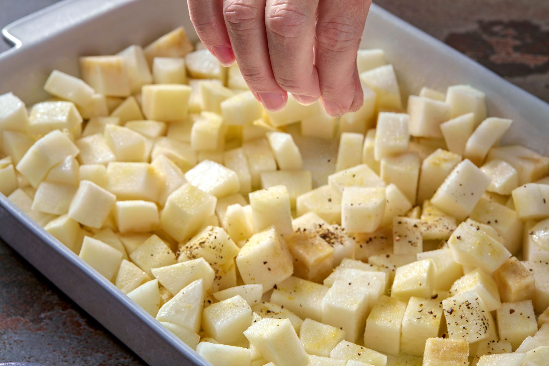 salt and pepper being sprinkled over turnips