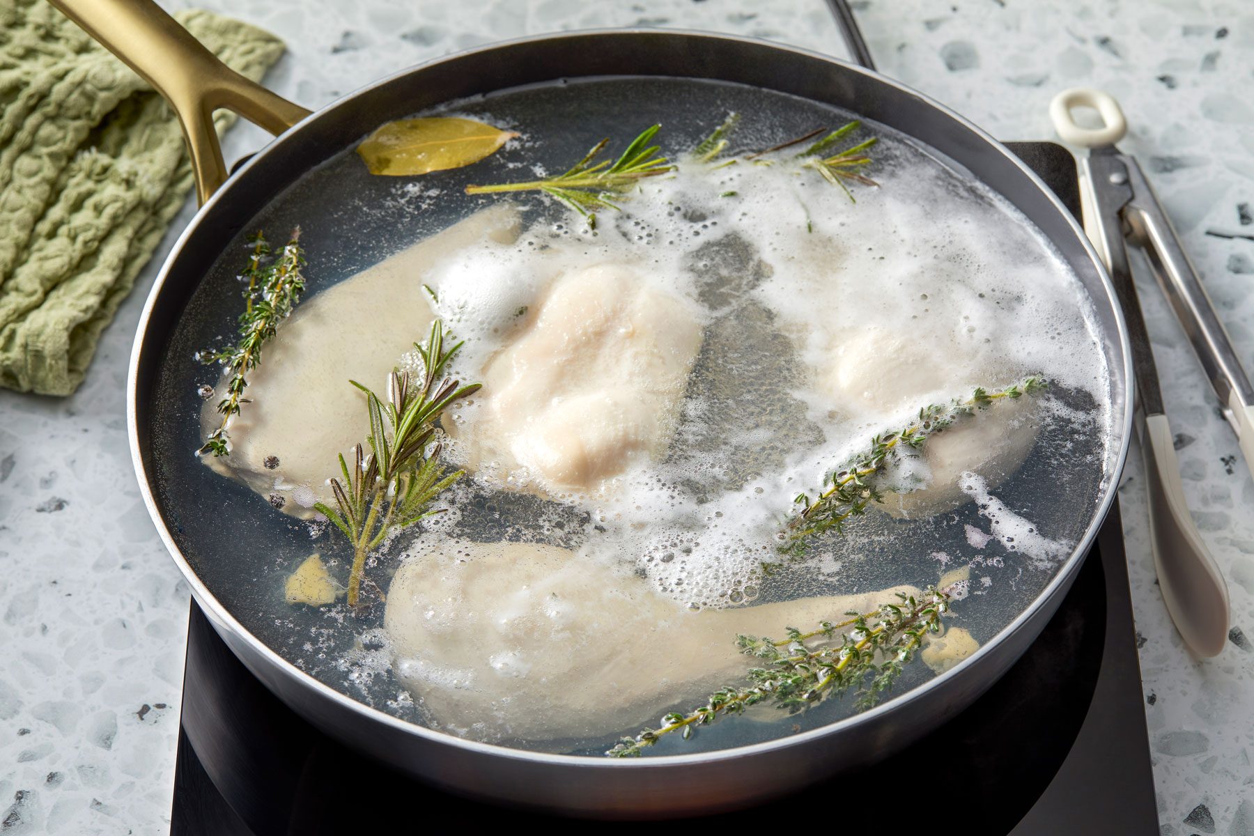 chicken in water being heated