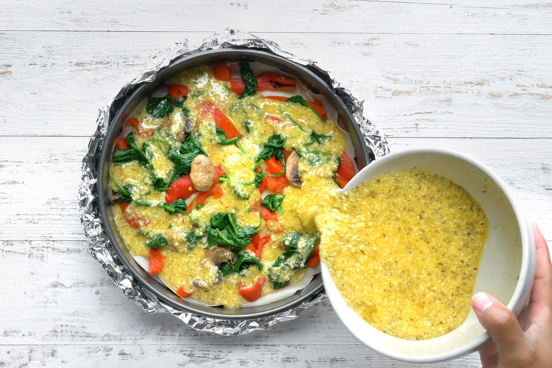 Pour half the egg mixture over top.