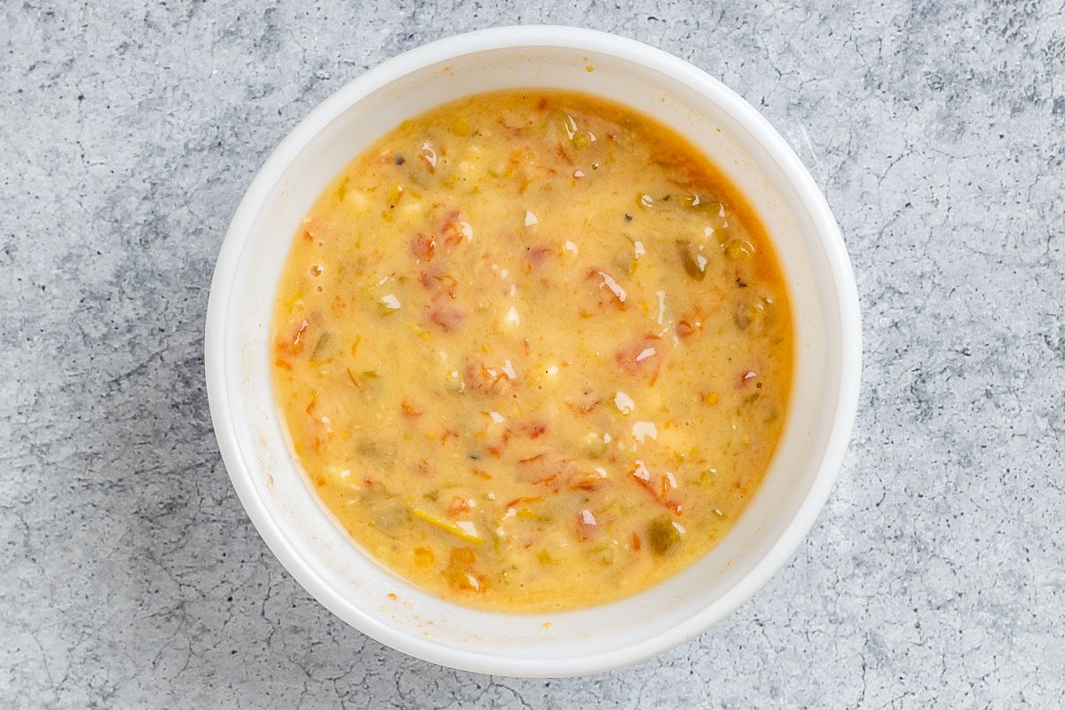 Taste of Home Nacho Casserole photo of the soup, tomatoes, and green chiles combined in a bowl.