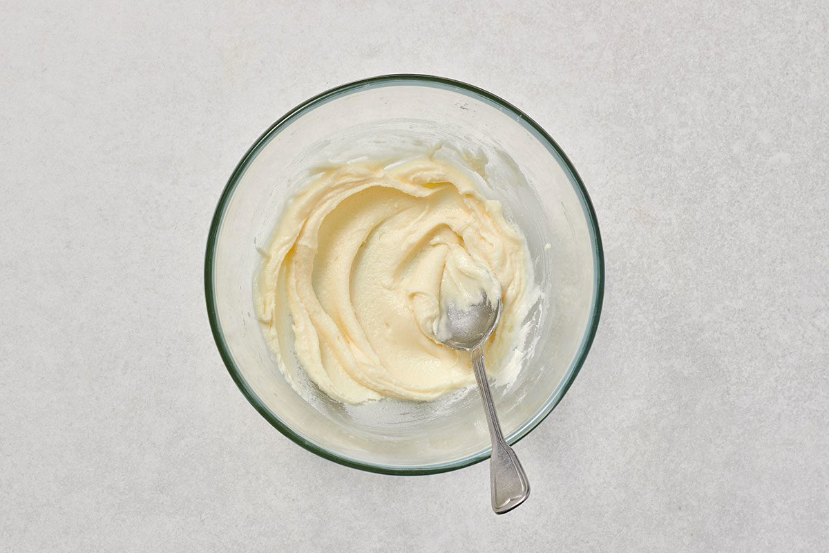 Frosting ingredients mixed together in a bowl.