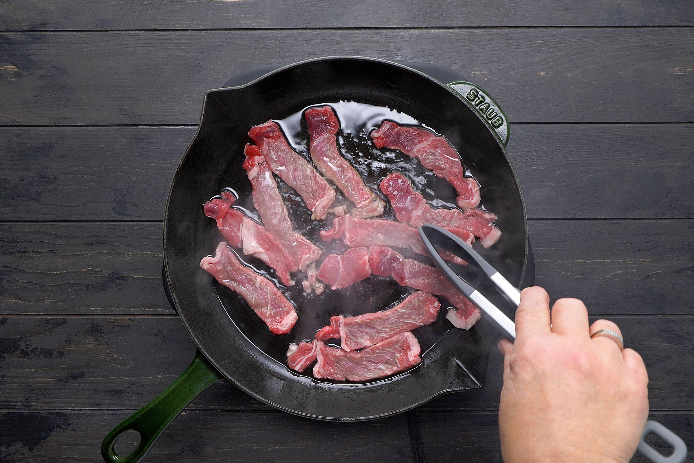 Sautéing ribeye beef in a large skillet