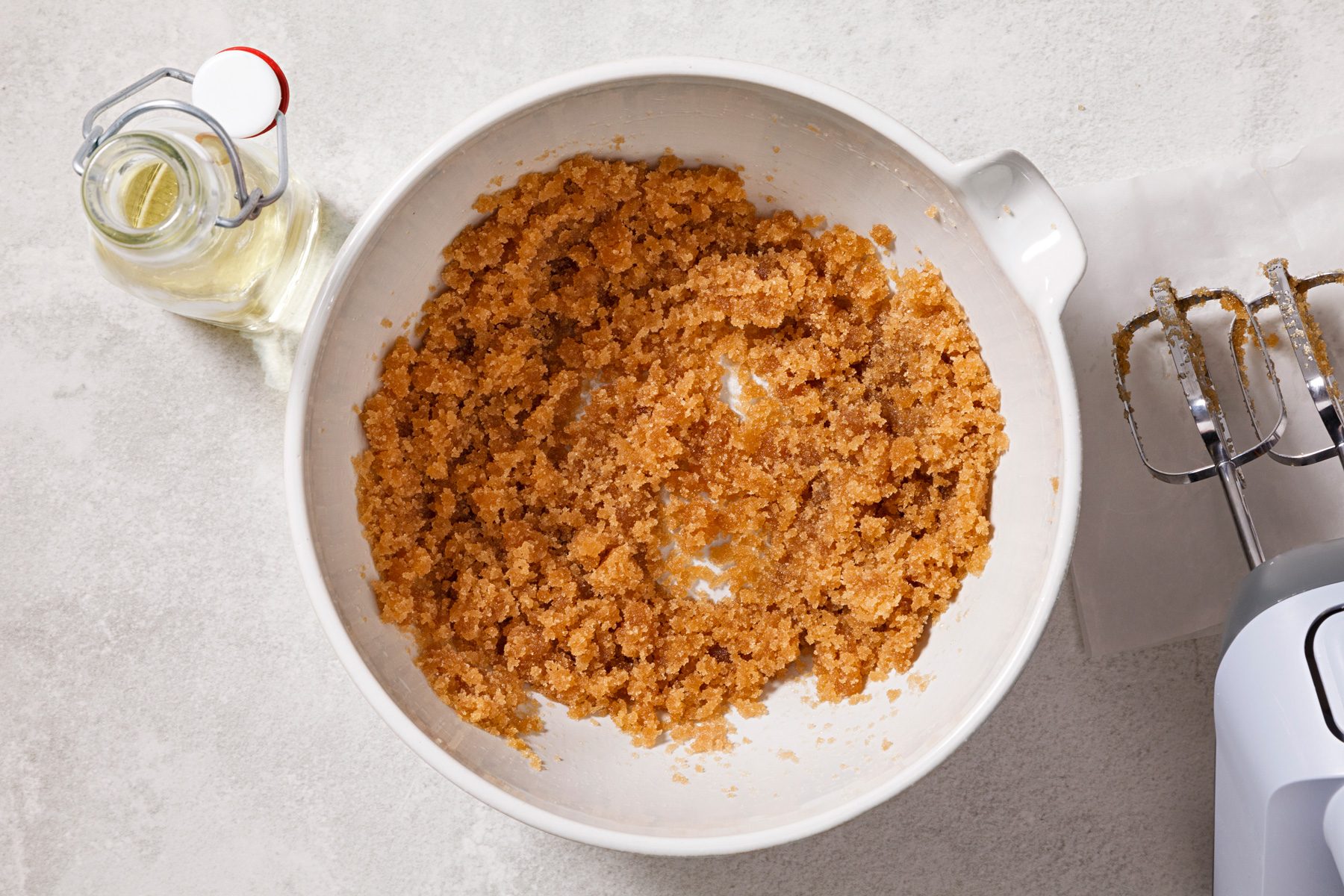 In a large bowl, beat together brown sugar and oil until combined.