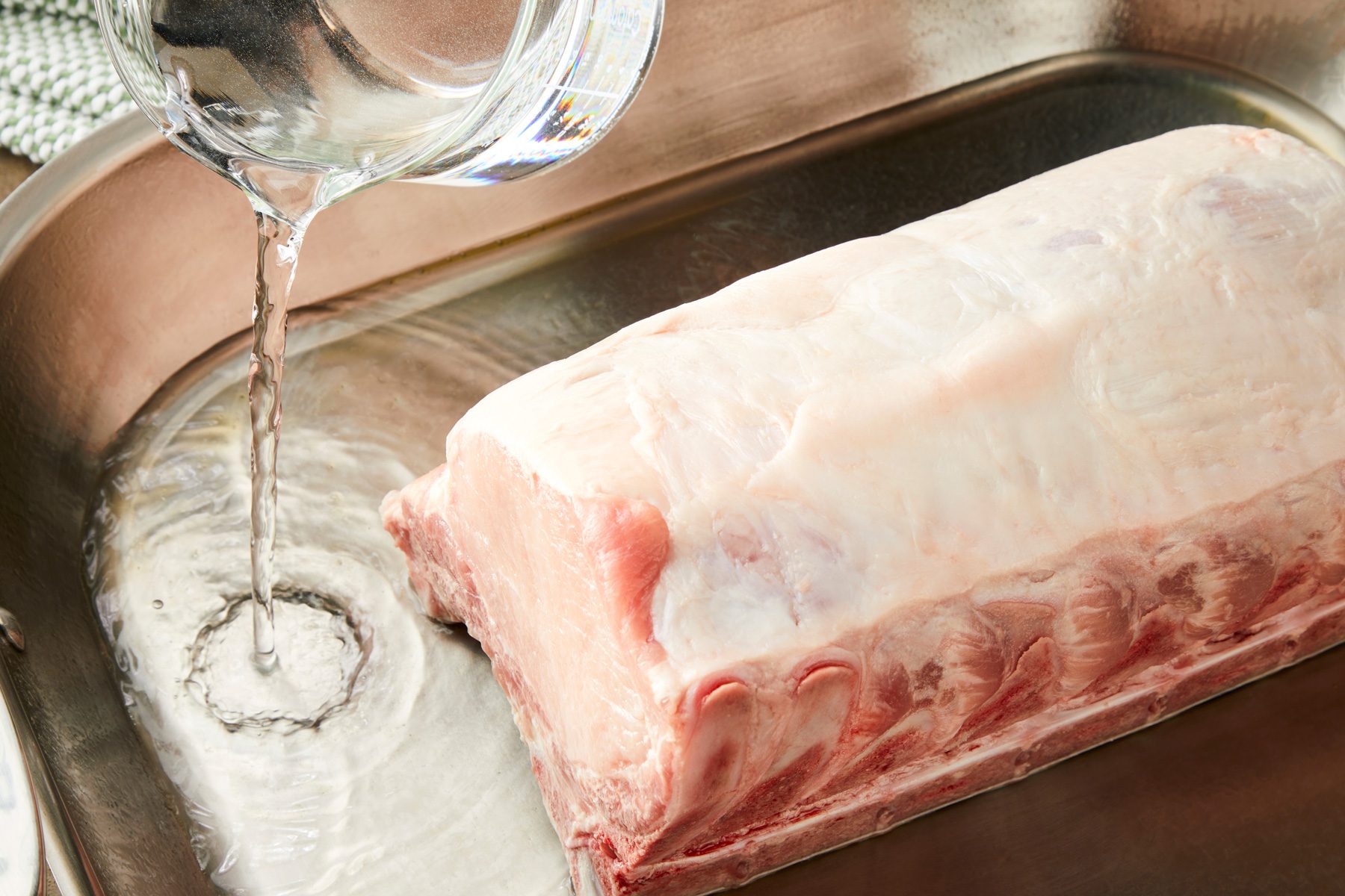 3/4th shot of Placing roast fat side up in a roasting pan; Pour remaining water into the pan