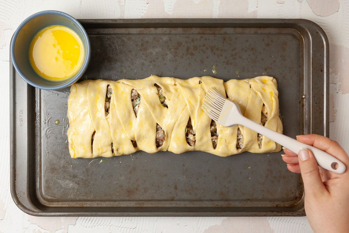 Step 2 of Taste of Home Sausage Braid is to assemble the braid and brush with egg wash