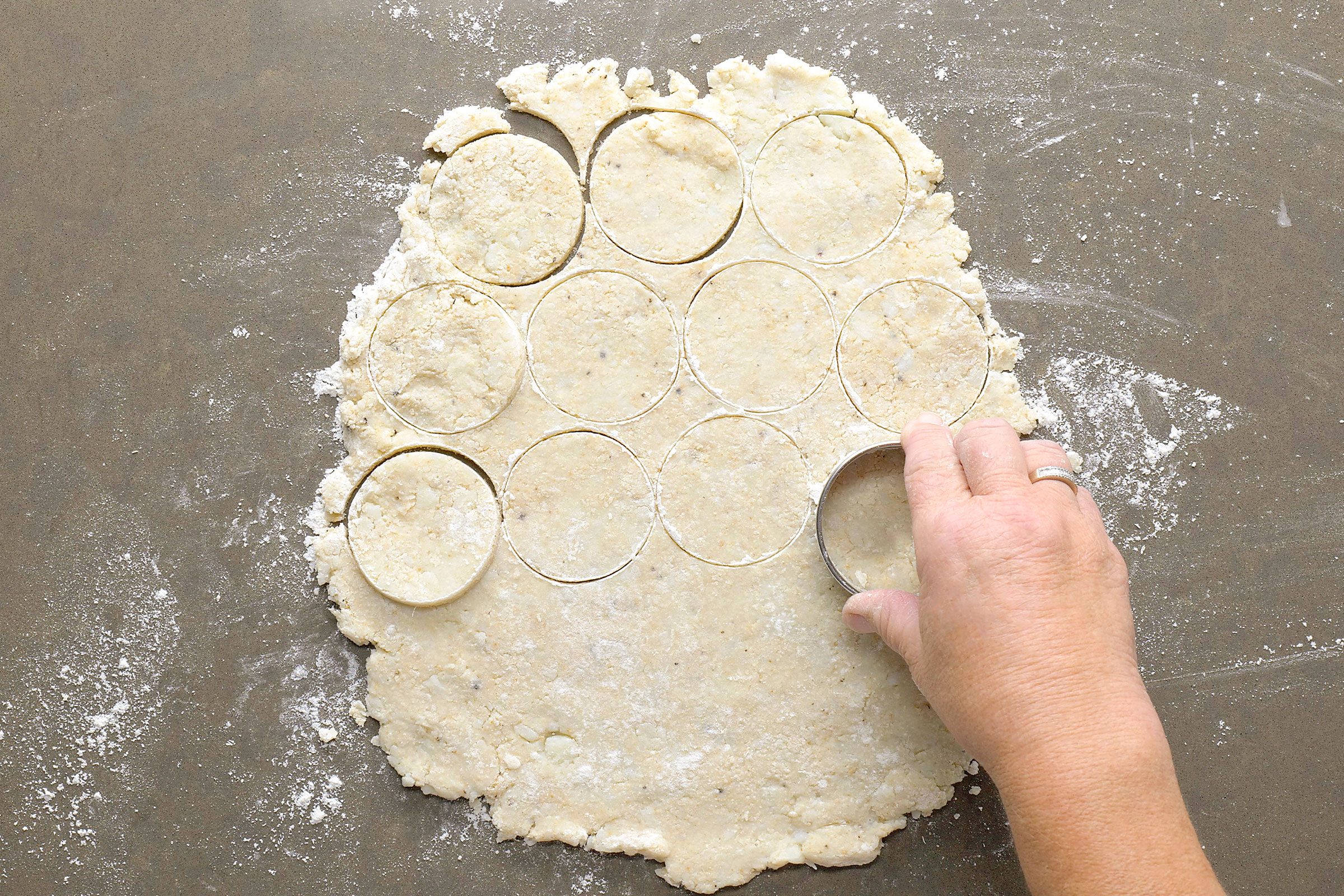 Cutting potato dough with a round cookie cutter