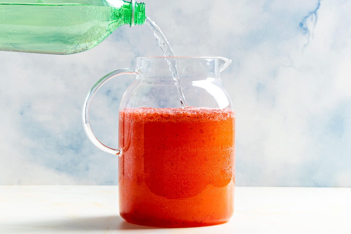 Taste of Home Sprite and Strawberry Drink photo of combining all the ingredients in a pitcher.