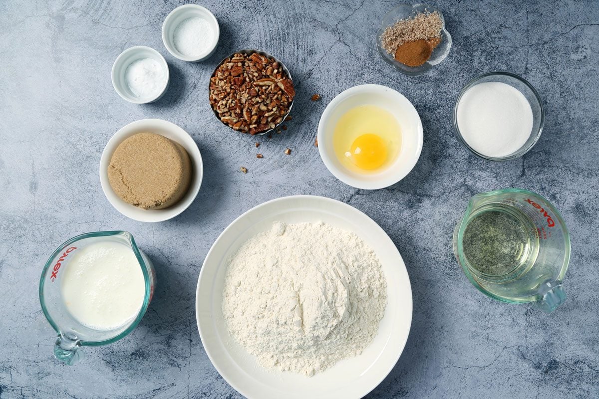 Ingredients for Taste of Home's Buttermilk Coffee Cake laid out in small bowls on a light blue surface.