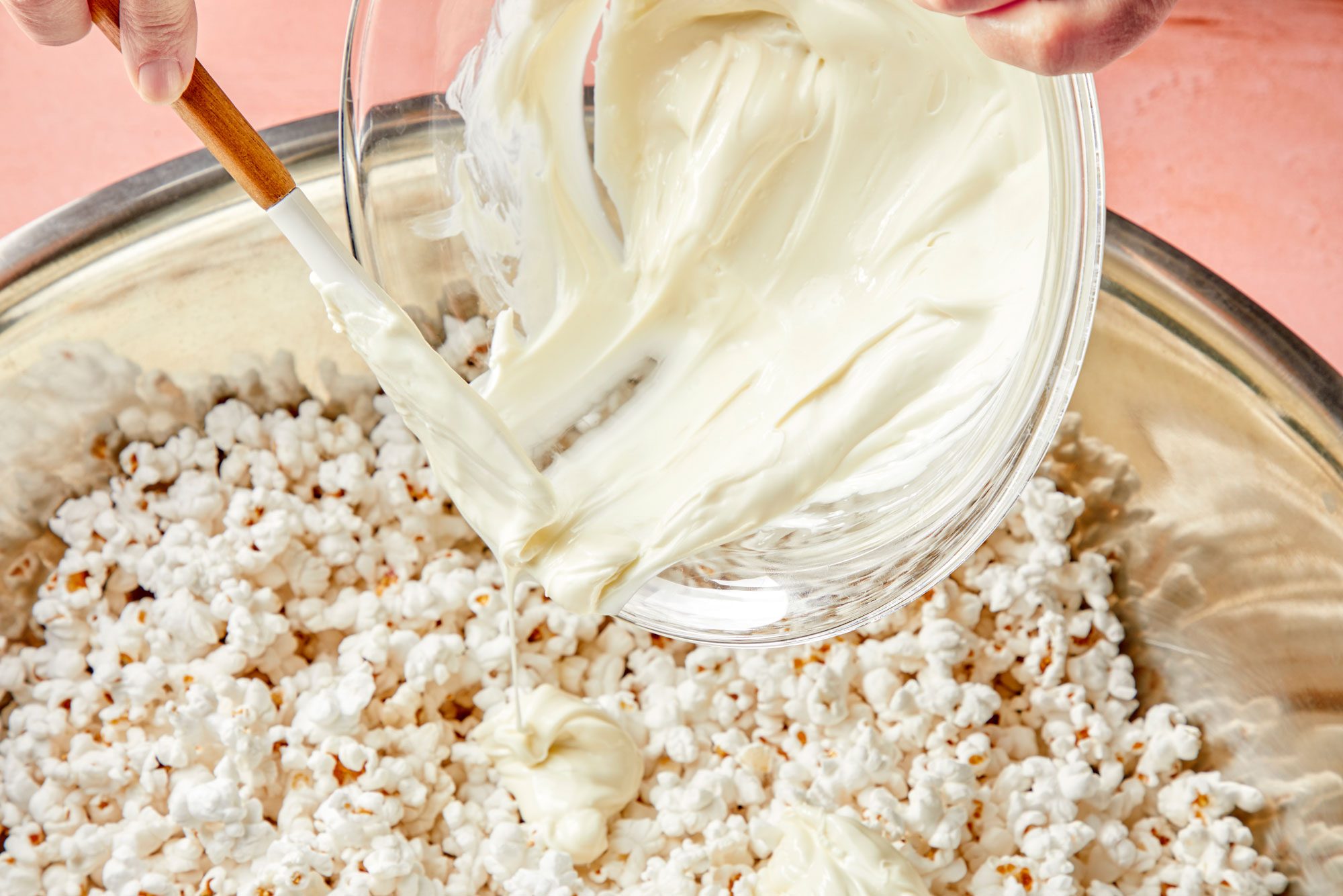 3/4th shot of a large bowl, combined the popcorn and crushed candy; Pouring candy coating over top;