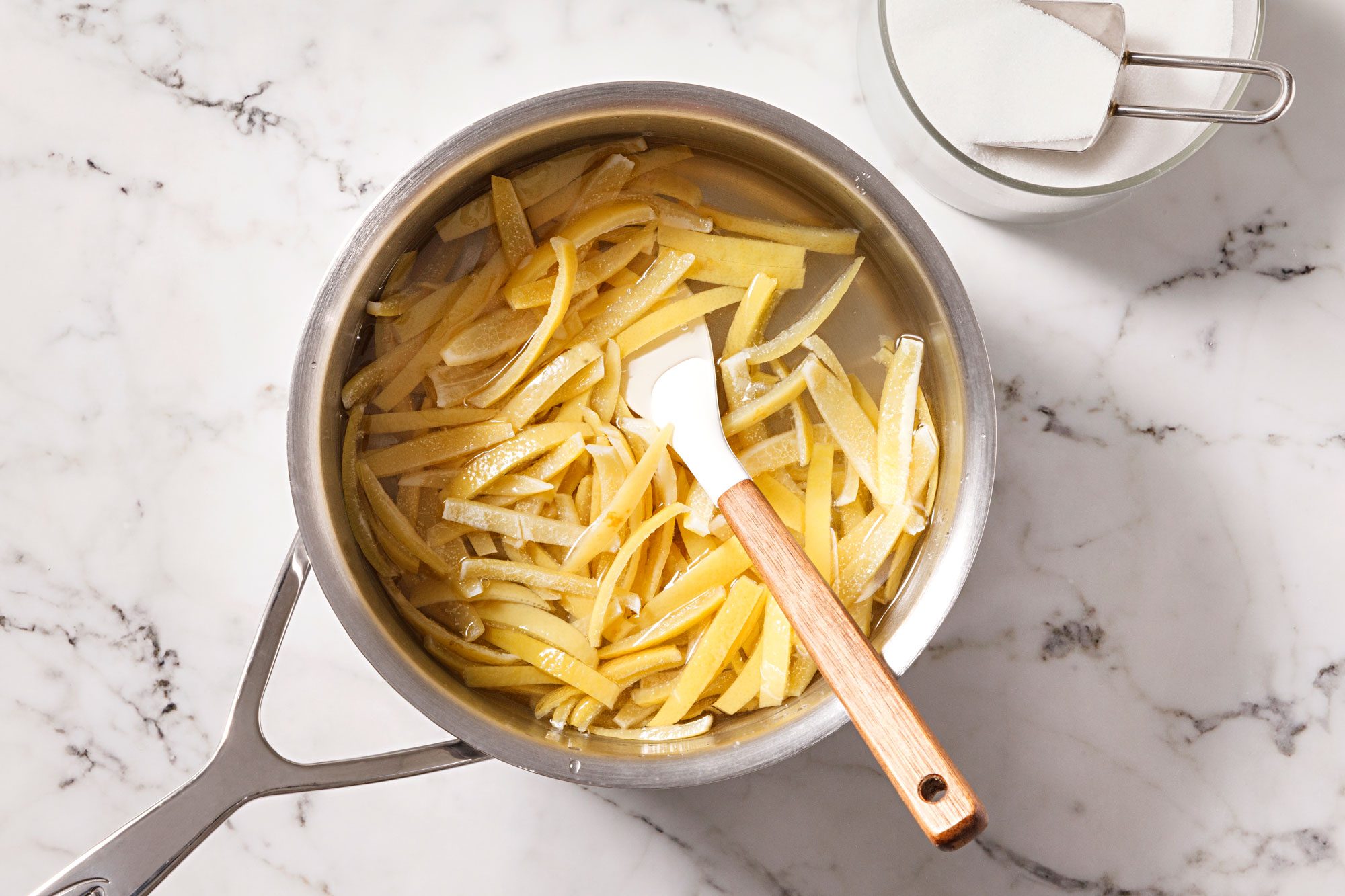 Place peel in a large heavy saucepan and cover with cold water, bring to a boil.