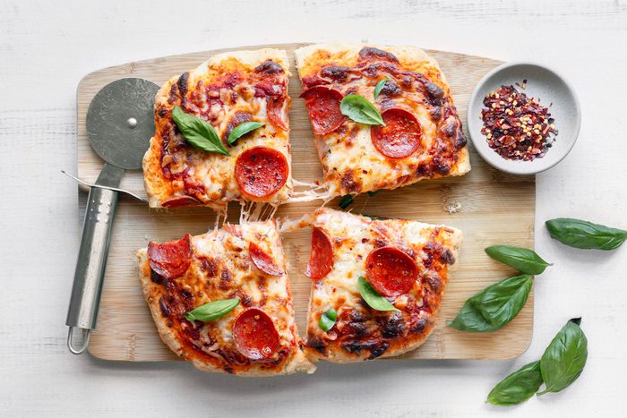 pizza sliced into four parts