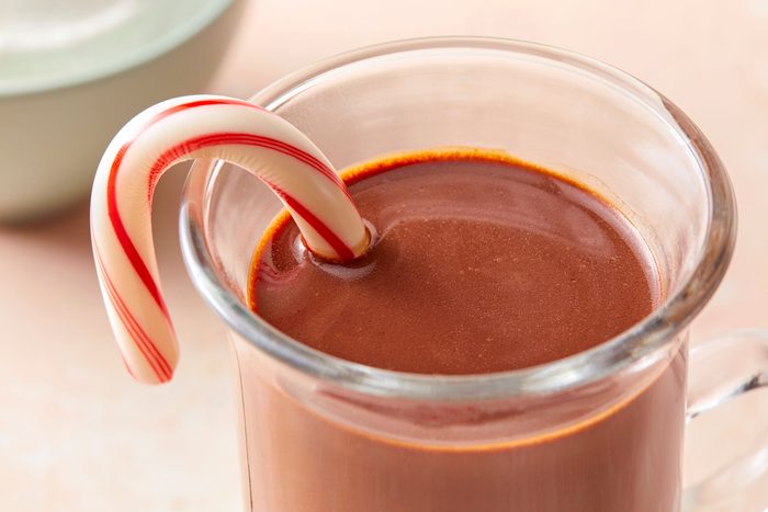Rich Peppermint Hot Chocolate served in a glass with candy in it