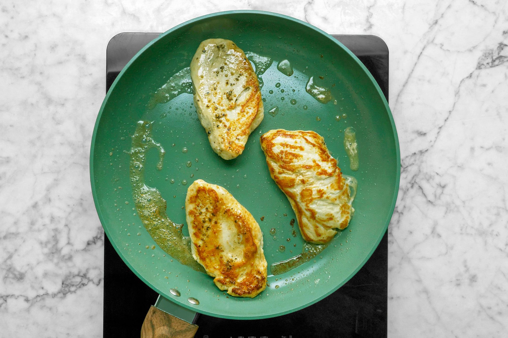 heat butter and oil over medium heat; add chicken; cook 4-5 minutes on each side or until no longer pink; remove chicken from pan; keep warm; induction; marble surface