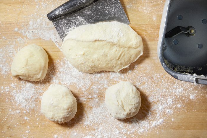dough being shaped into balls