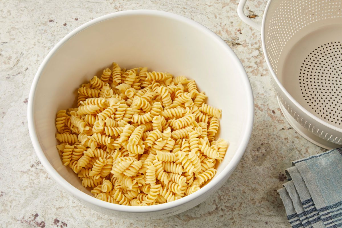 Cook pasta according to package directions. Drain and transfer to a large bowl.