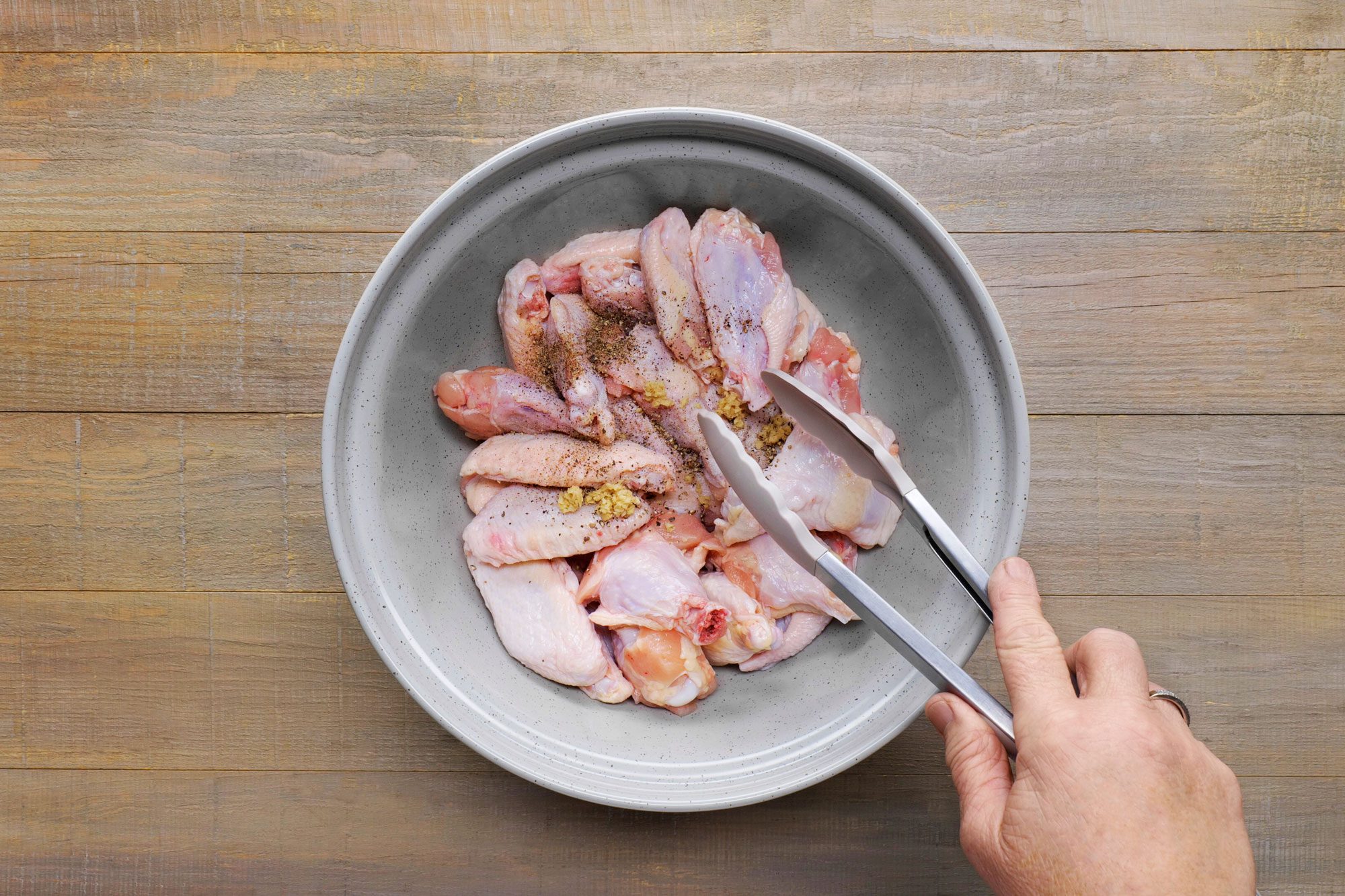 Prepare wings for cooking with black pepper and garlic