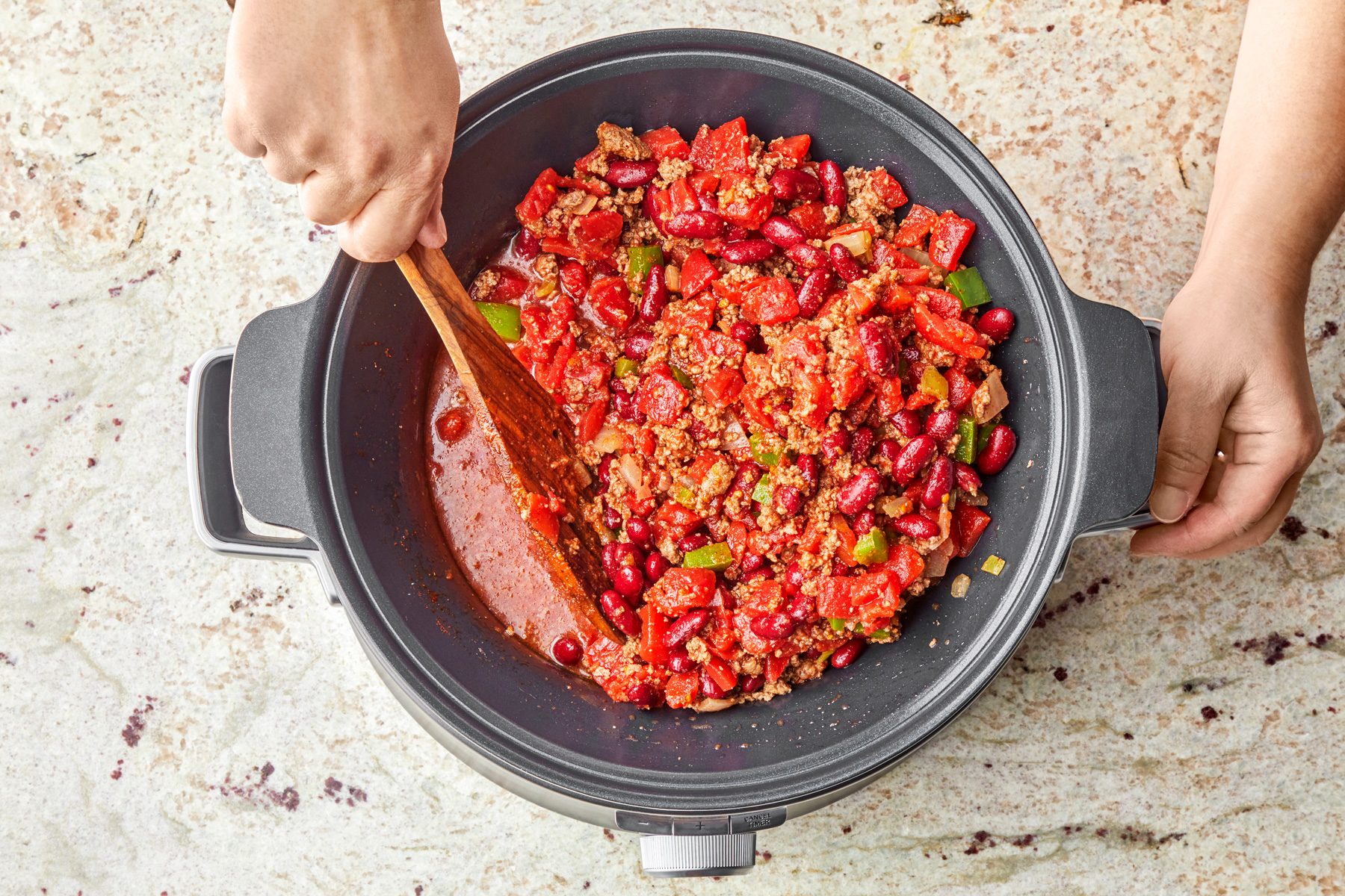stir tomatoes, beans, chili powder, cumin in to slow cooker.