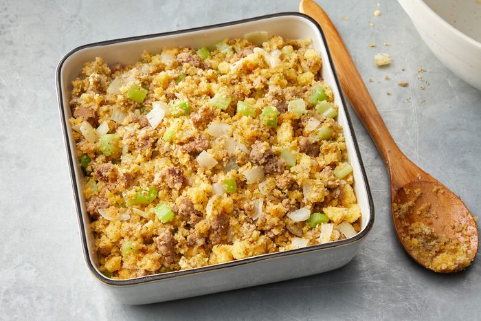 Close shot of transfer to prepared dish; bake until golden brown 25-30 minutes; Serve warm; wooden spoon; marble surface