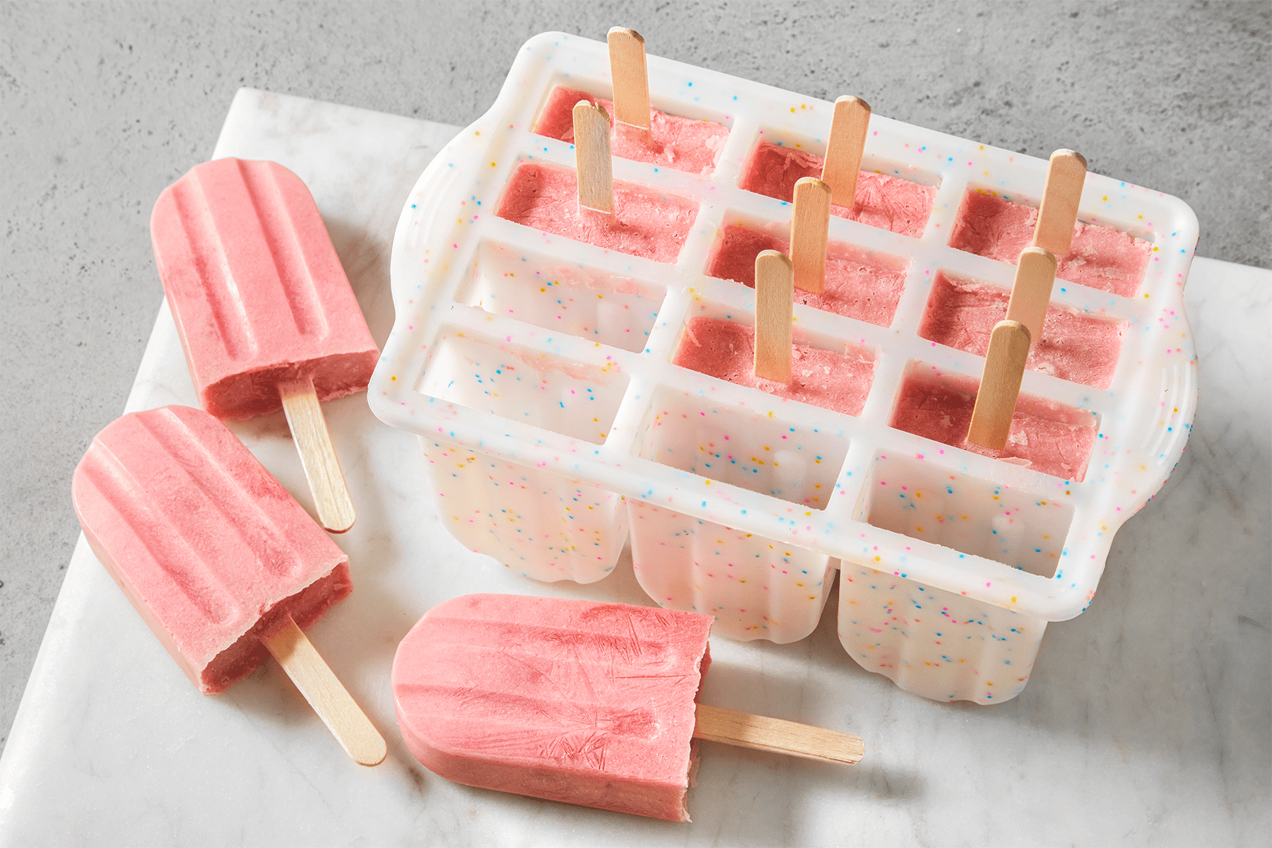 Strawberry Banana Popsicles on a countertop