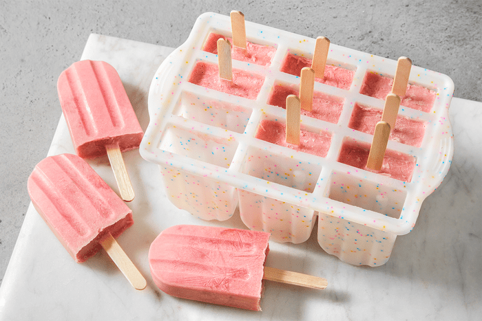Strawberry Banana Popsicles on a countertop