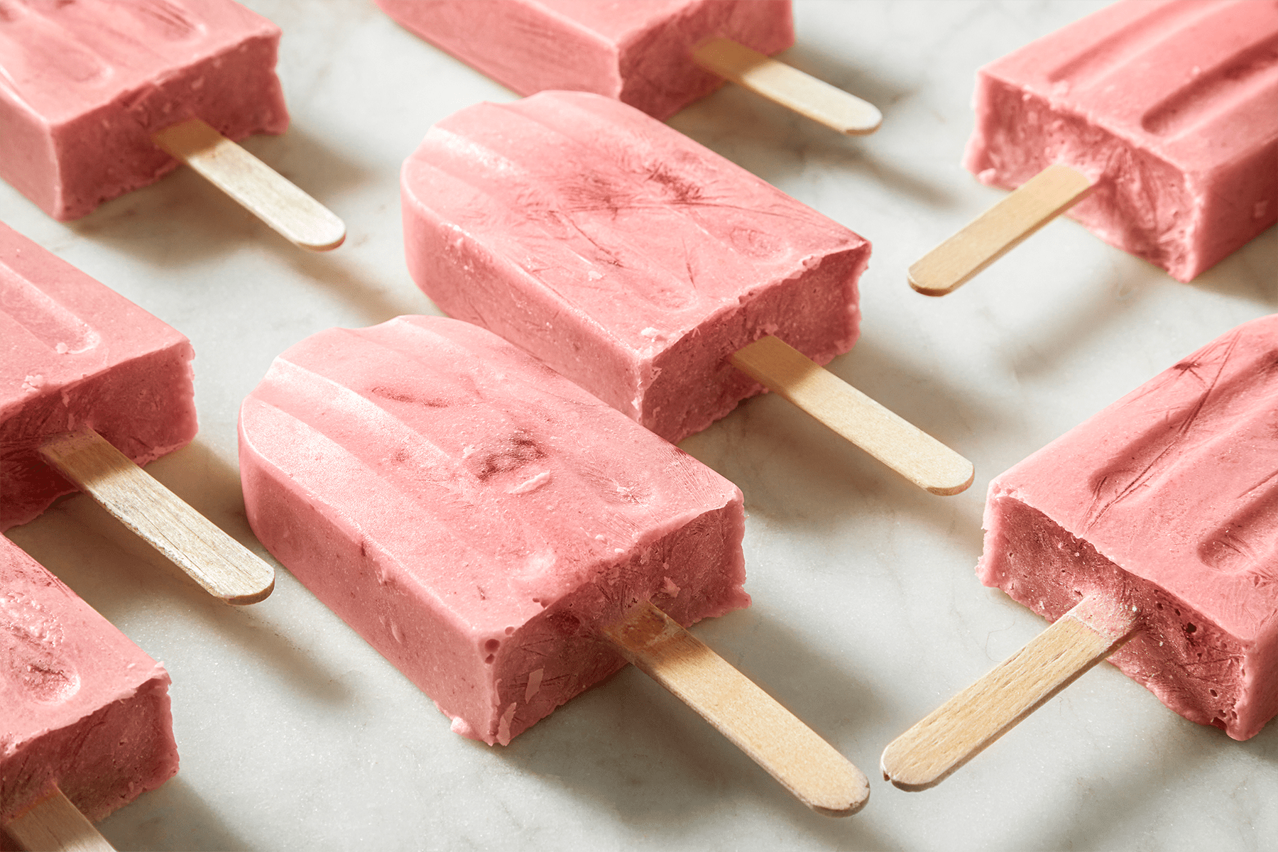 Strawberry Banana Popsicles on a countertop
