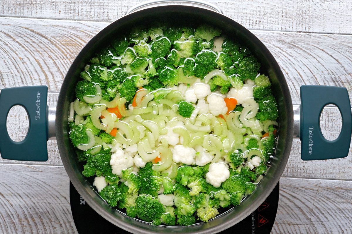 cooking macaroni with broccoli, cauliflower, carrots and celery in a 6-quart stockpot