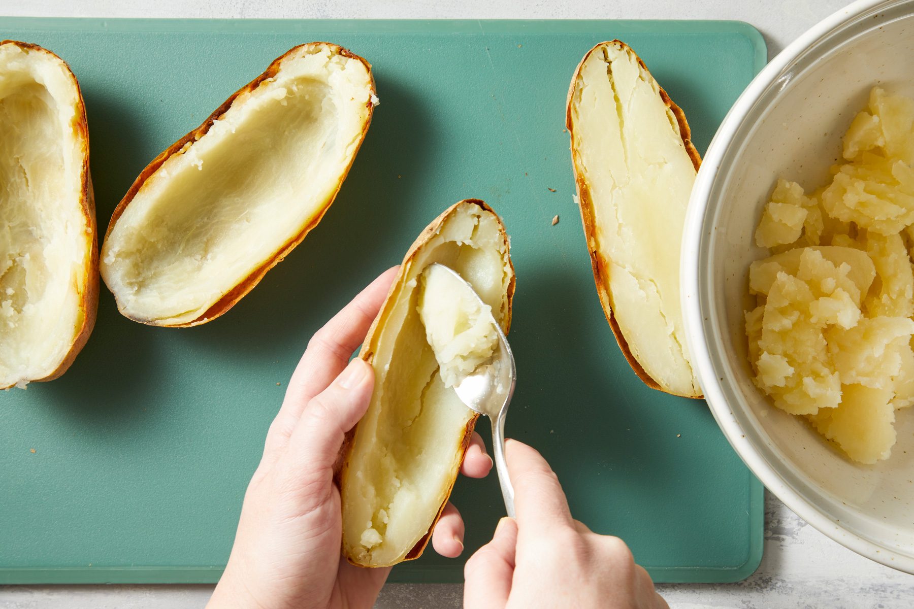 Cut potatoes in half lengthwise; scoop out pulp, leaving a 1/4-in. shell.