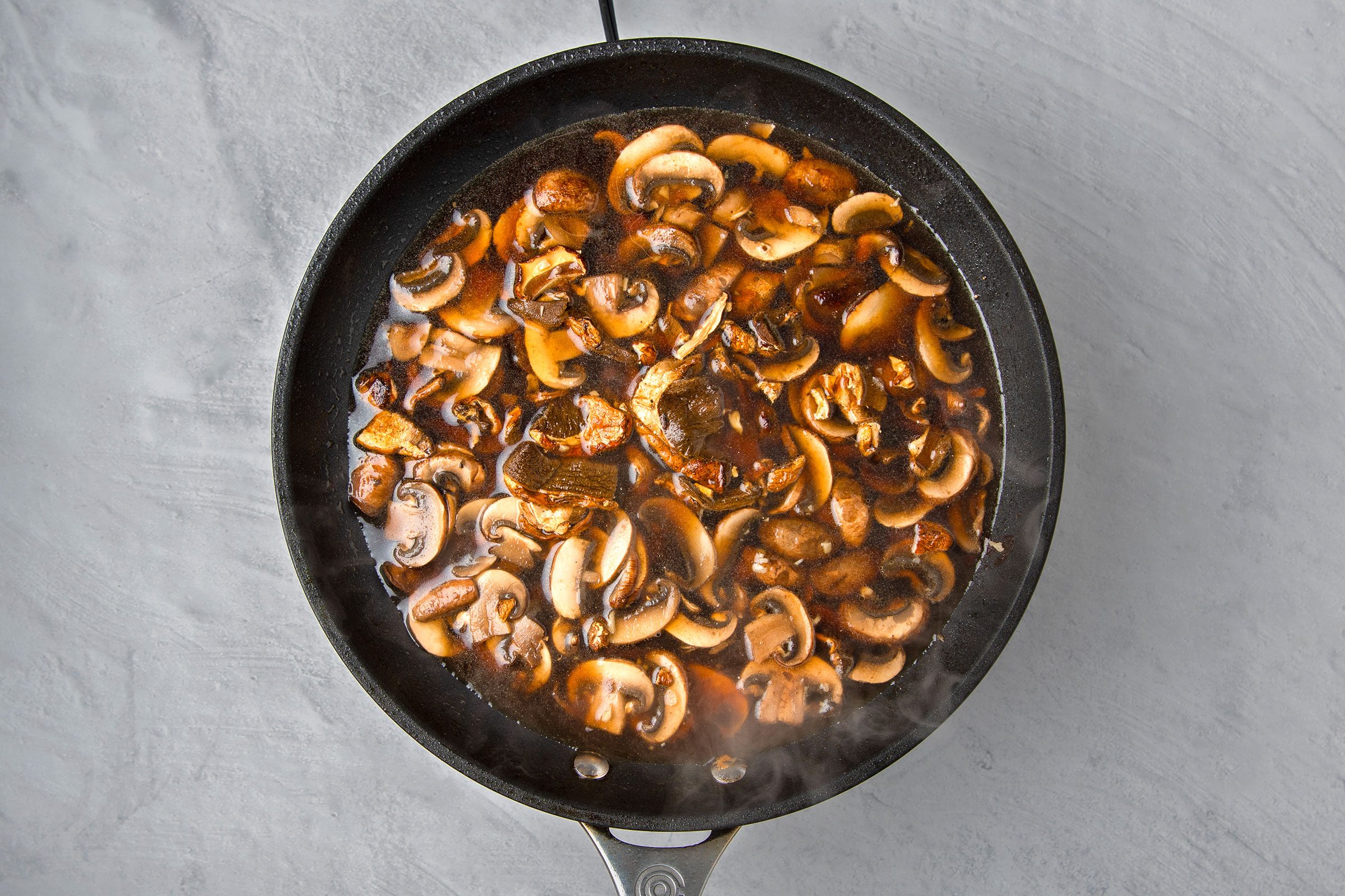 Mushrooms, garlic and Marsala wine cooking together in olive oil