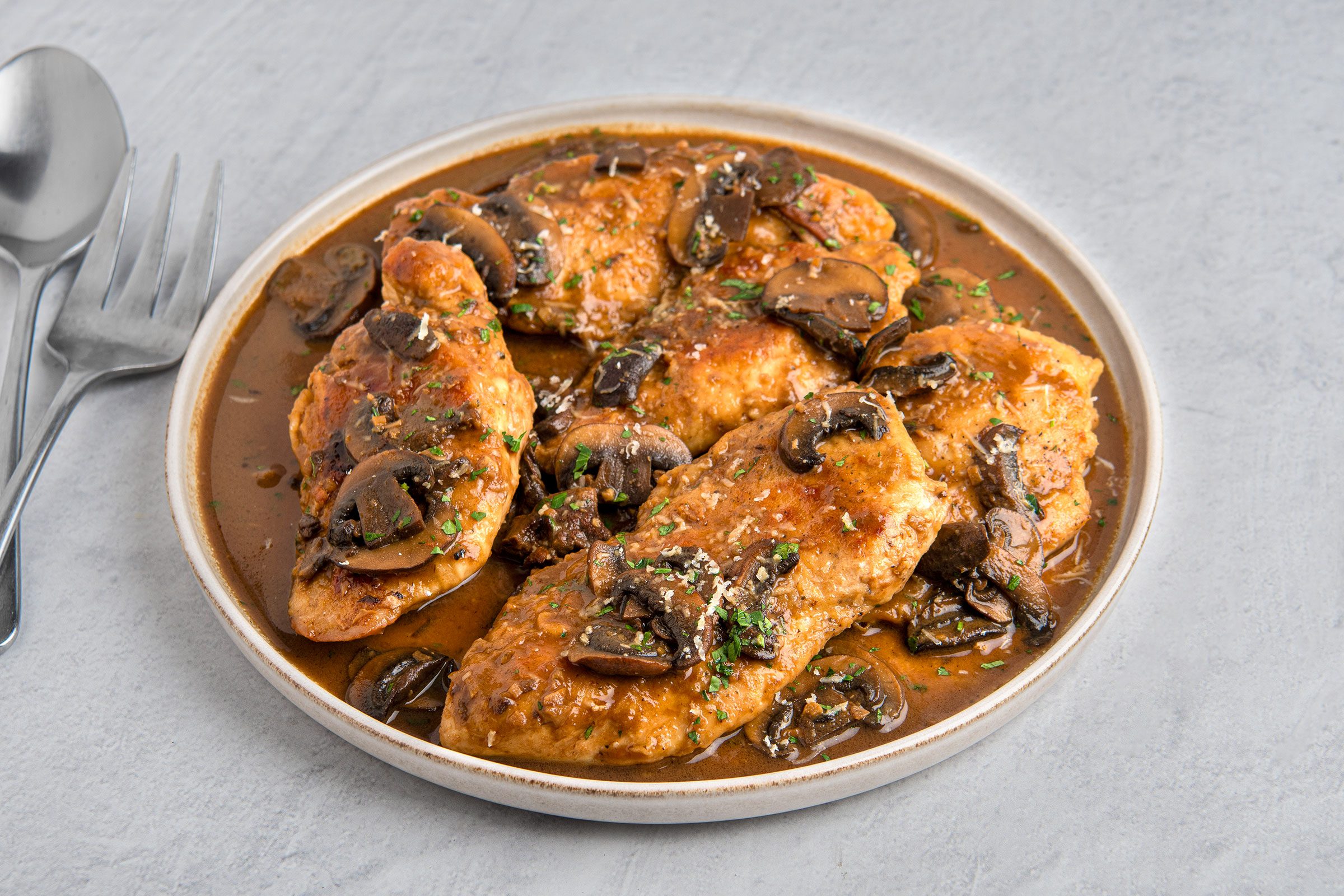 Copycat Olive Garden Chicken Marsala served in a white plate
