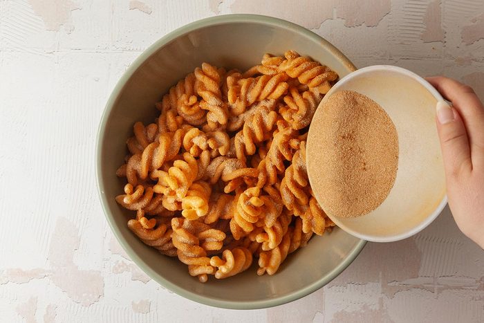 Cinammon, sugar mix are being poured into duros twist