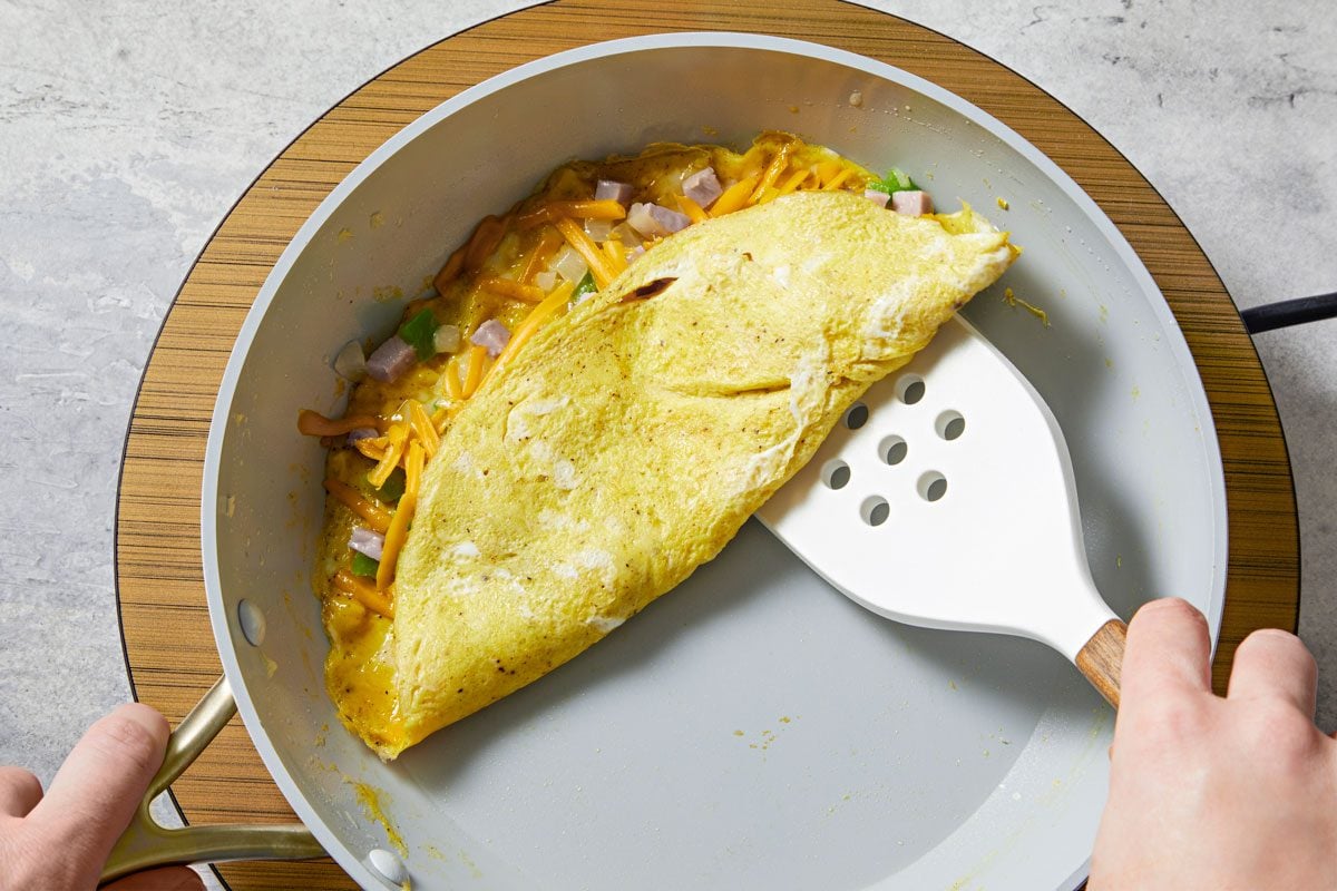 As eggs set, push cooked edges toward the center, letting uncooked portion flow underneath.