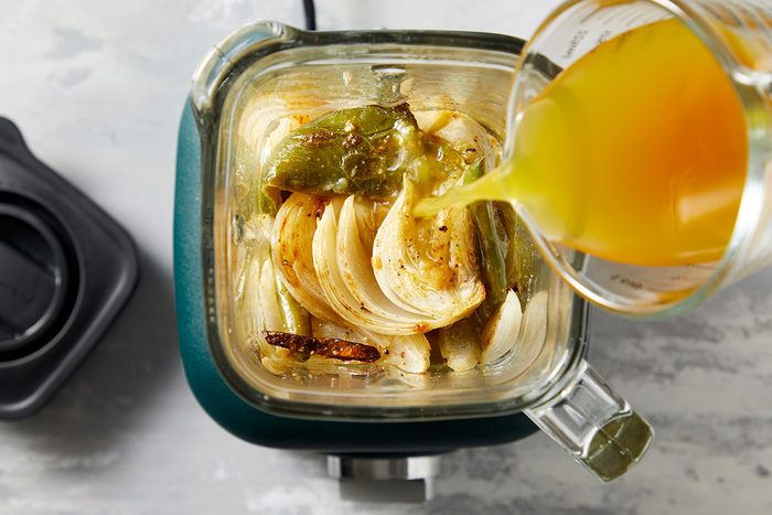 Overhaed shot of transfer to a blender; add broth; Puree until smooth