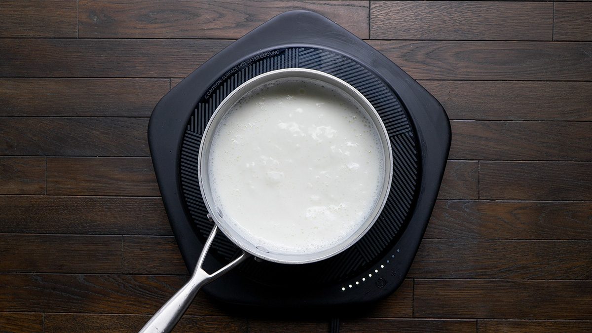 In a large saucepan or pot bring whole milk and water to a boil