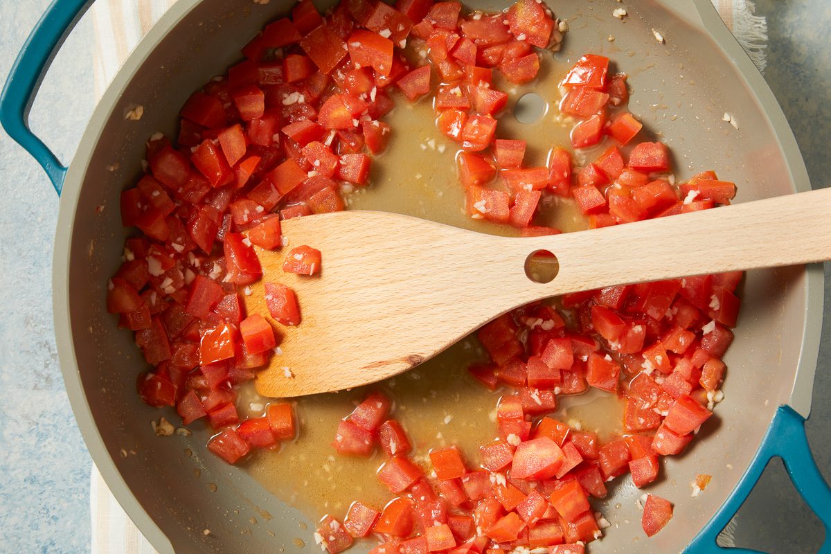 chopped tomatoes added to skillet