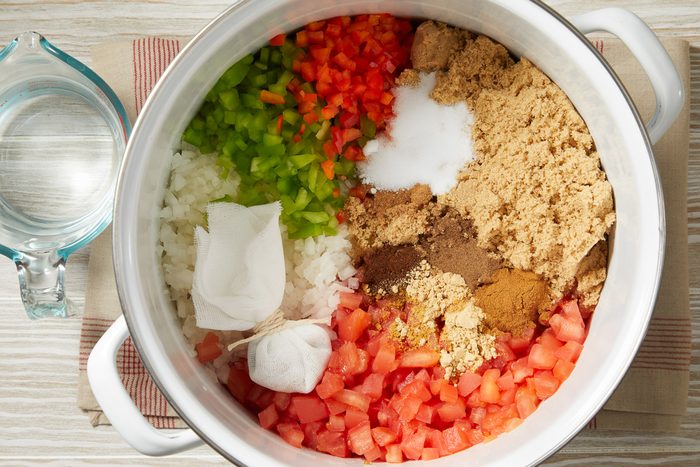 choppes vegetables and bag of seeds in a pot