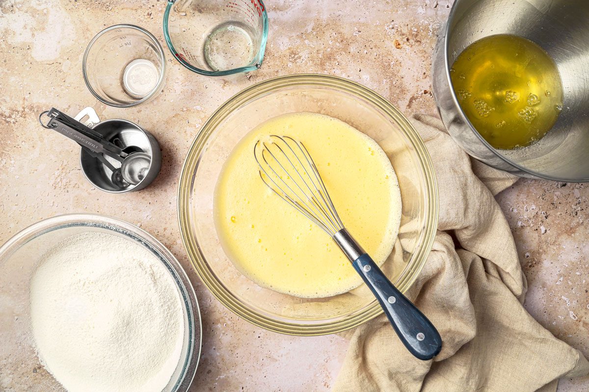 In a bowl mix egg yolks; water; oil and vanilla extract