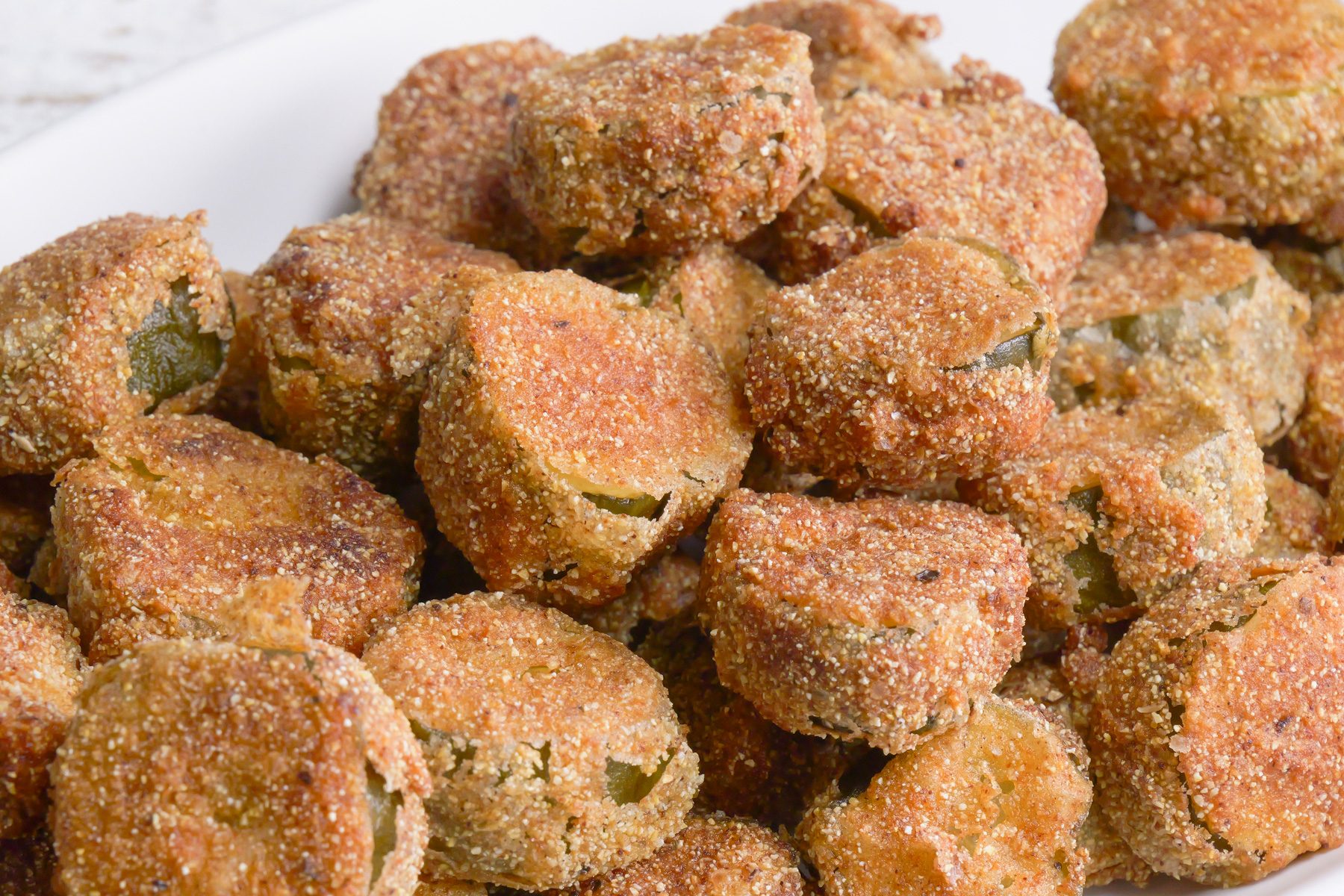 Close-up shot of Fried Dill Pickles; served on large platter