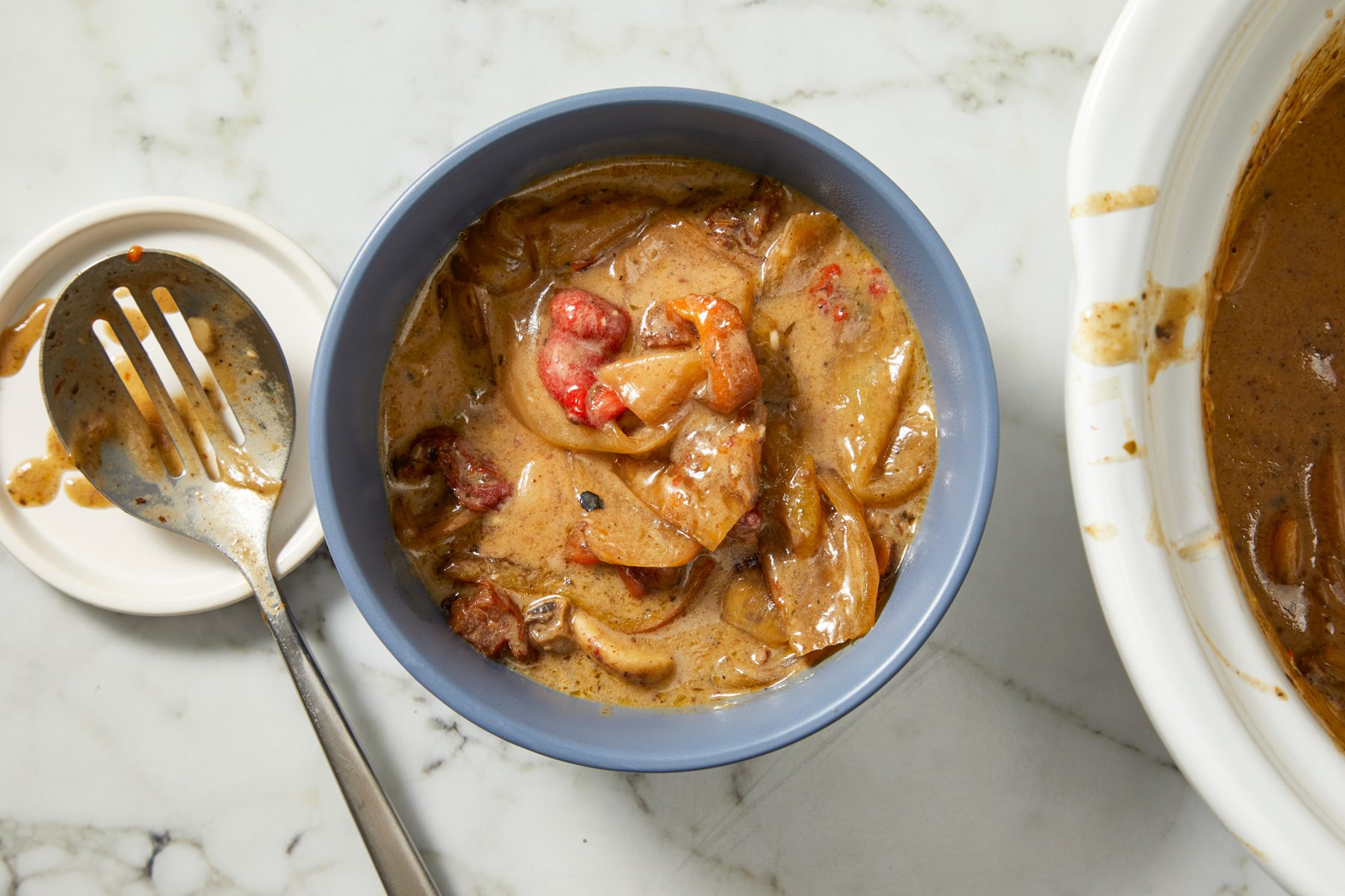 Vegetables removed from slow cooker liquid with slotted spoon, set aside in small bowl.