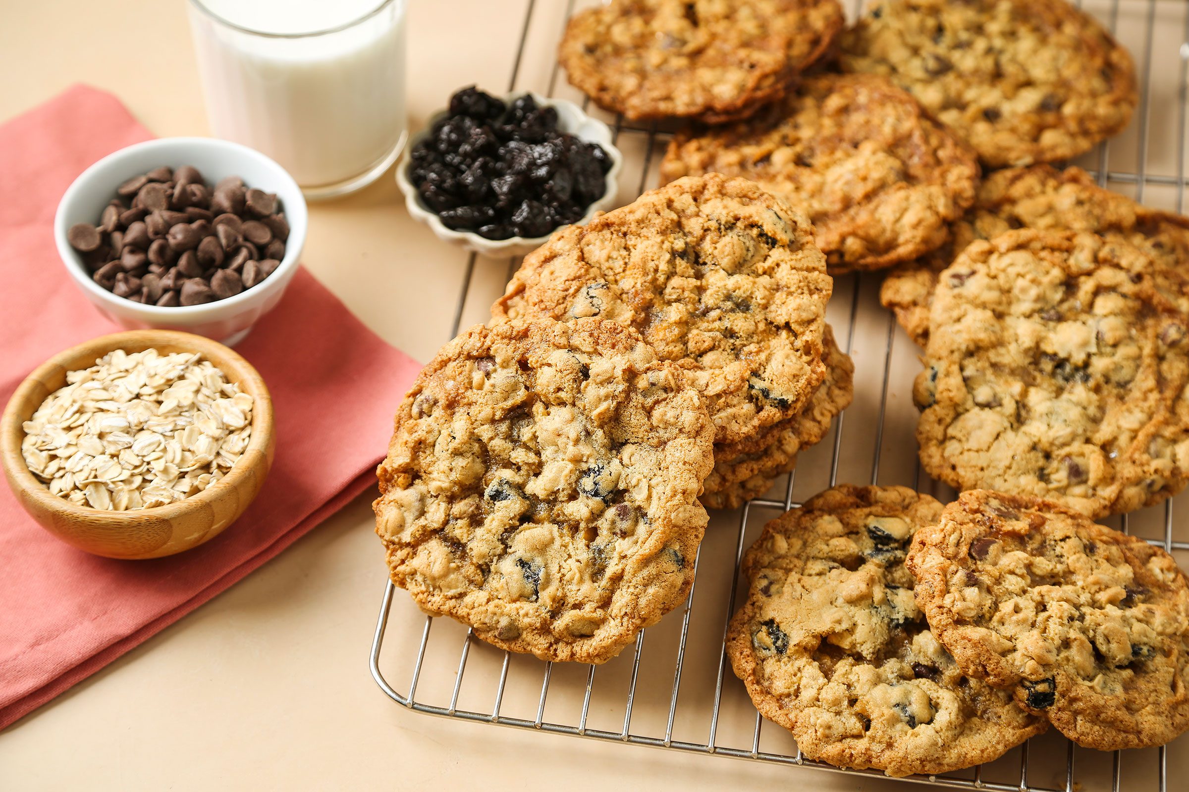 Oatmeal Cherry Cookies with dried cherries, milk, oats and chocolate chips on side