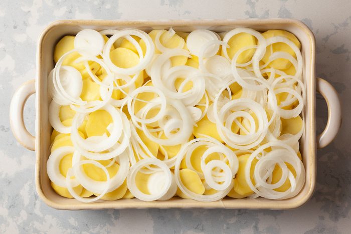 beef, potatoes and onion slices layered in a shallow 2-quart baking dish