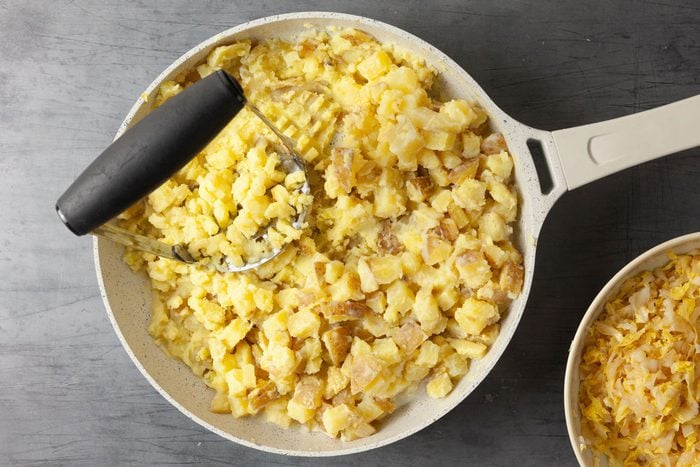 Combine the cooked potatoes with the butter, milk and mustard and mash