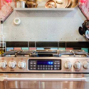 Pots and pans hanging over oven