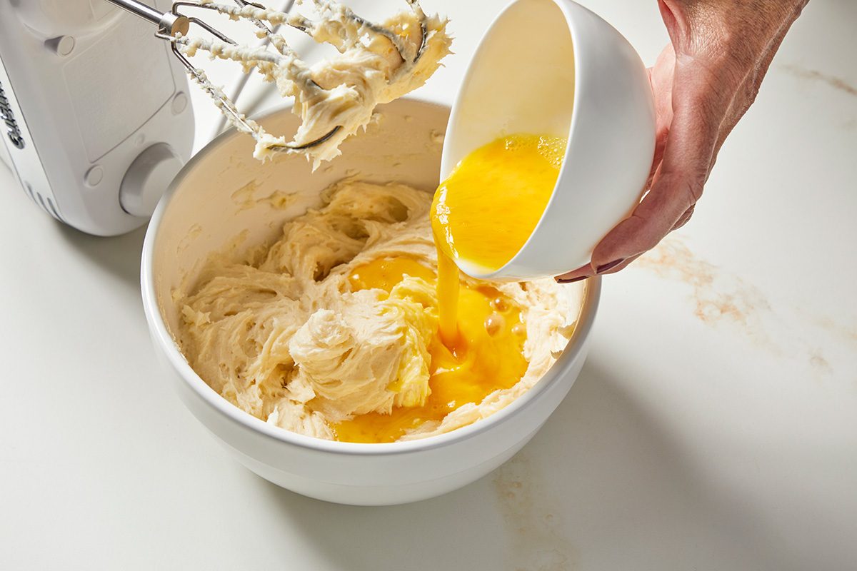 3/4 angle view shot of prepare brownie mix batter according to package directions; blender is nearby; all set on a marble surface;