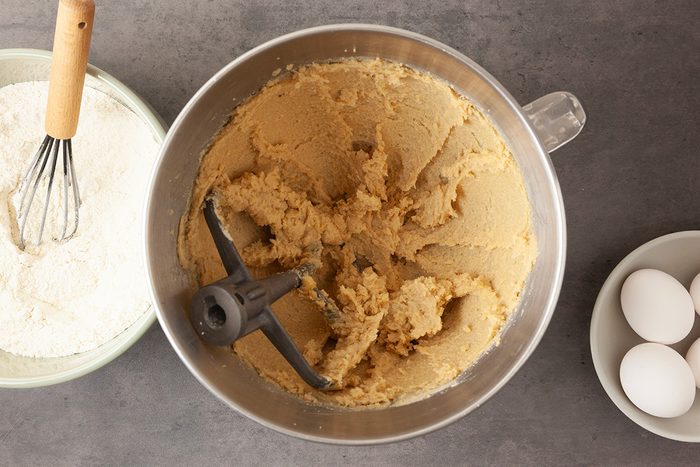 In a small bowl, whisk together flours, baking powder and salt. In a large bowl, cream butter and brown sugar until light and fluffy